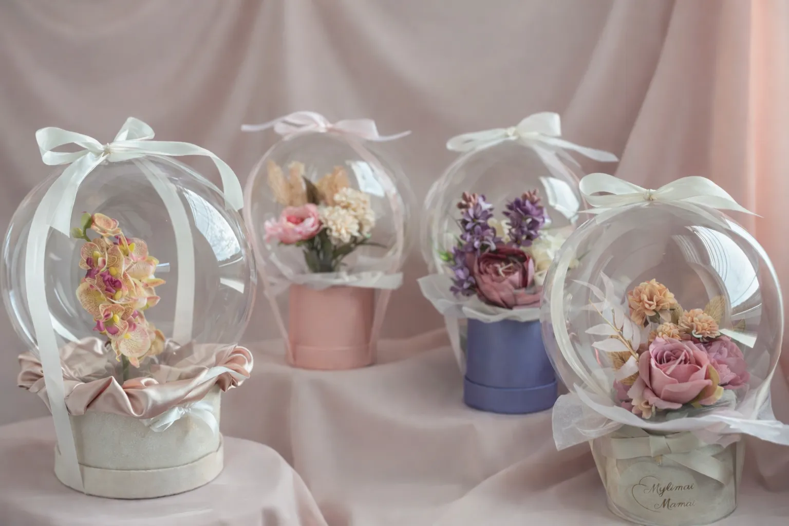 Floral balloon gift arrangements on a pastel background